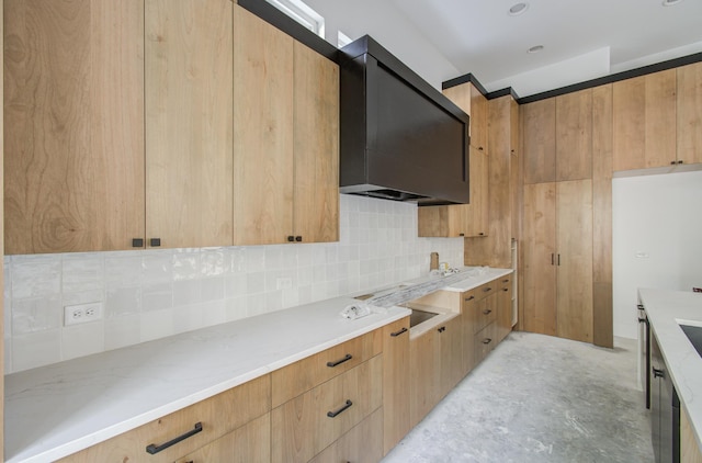 kitchen featuring wall chimney exhaust hood and tasteful backsplash