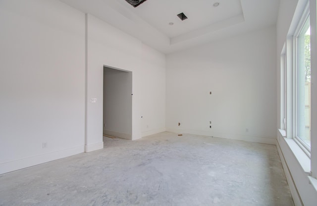 spare room with a tray ceiling