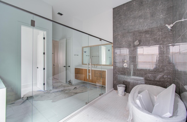 bathroom featuring vanity, separate shower and tub, and tile walls