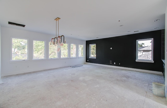 spare room featuring a chandelier