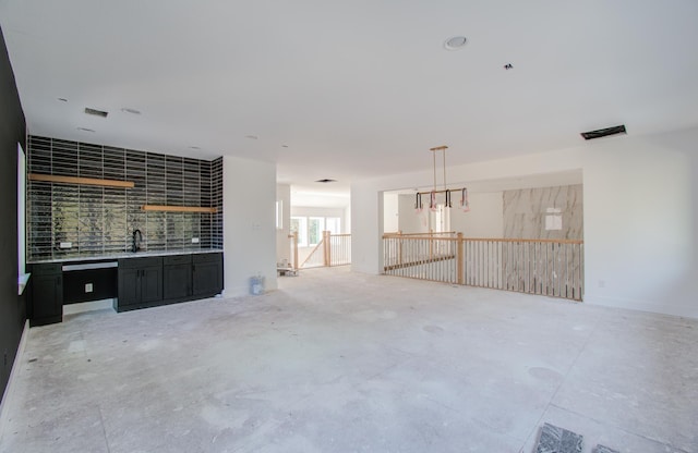 unfurnished living room with sink