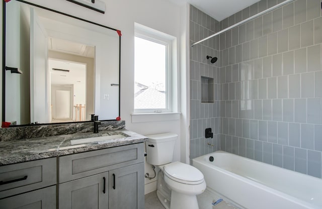 full bathroom featuring vanity, toilet, and tiled shower / bath combo