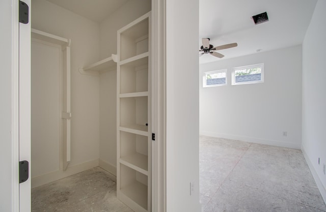 walk in closet featuring ceiling fan