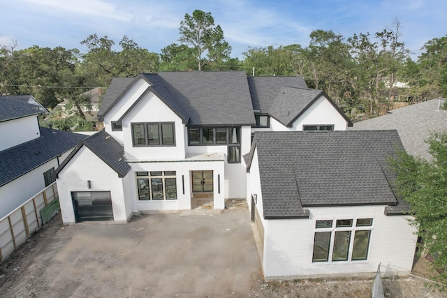 back of house featuring a garage