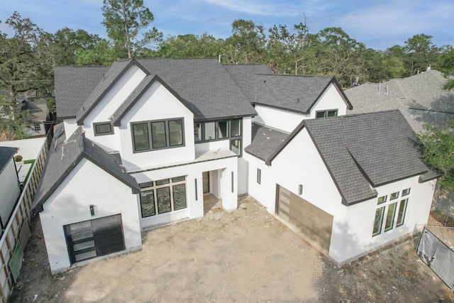 rear view of house with a garage