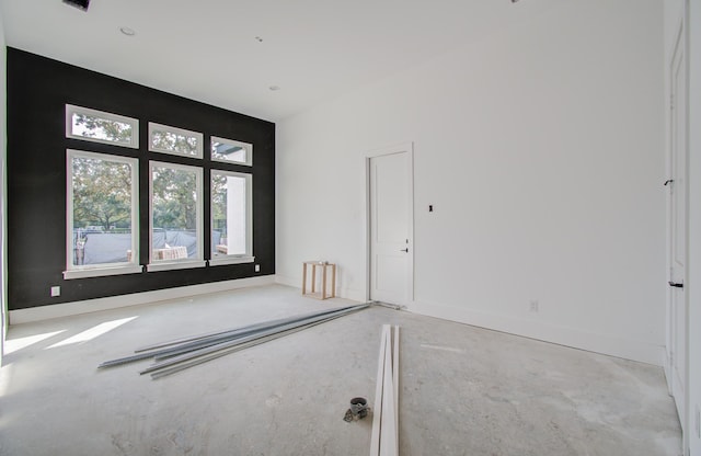 unfurnished room featuring concrete floors