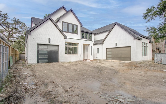 tudor-style house featuring a garage