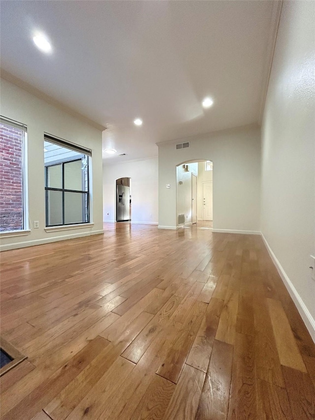 unfurnished living room with light hardwood / wood-style floors