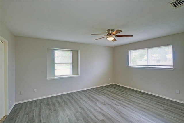 spare room with light hardwood / wood-style flooring and ceiling fan