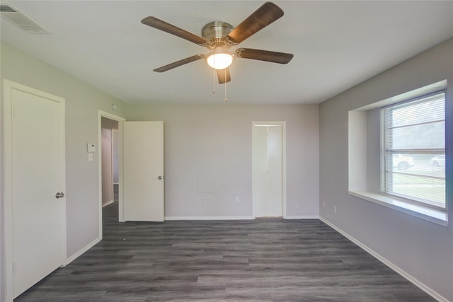 unfurnished room with ceiling fan and dark hardwood / wood-style flooring