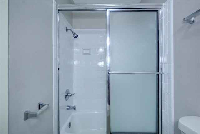 bathroom with toilet and enclosed tub / shower combo