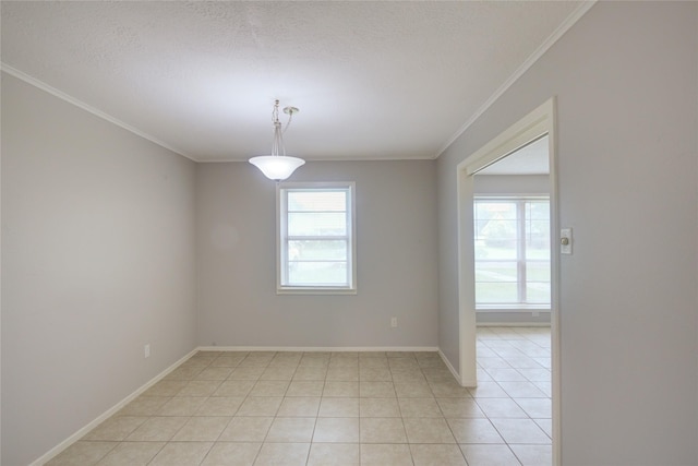 unfurnished room with light tile patterned floors, a textured ceiling, and ornamental molding