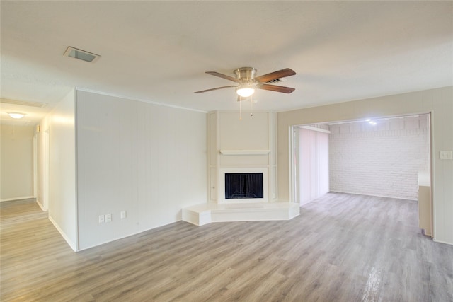 unfurnished living room with ceiling fan and light wood-type flooring