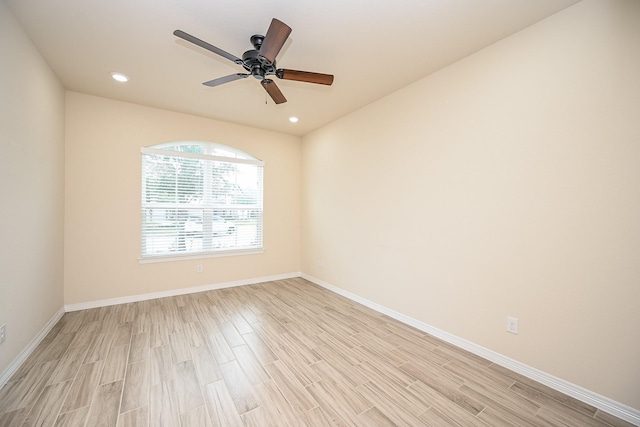 empty room featuring ceiling fan and light hardwood / wood-style floors