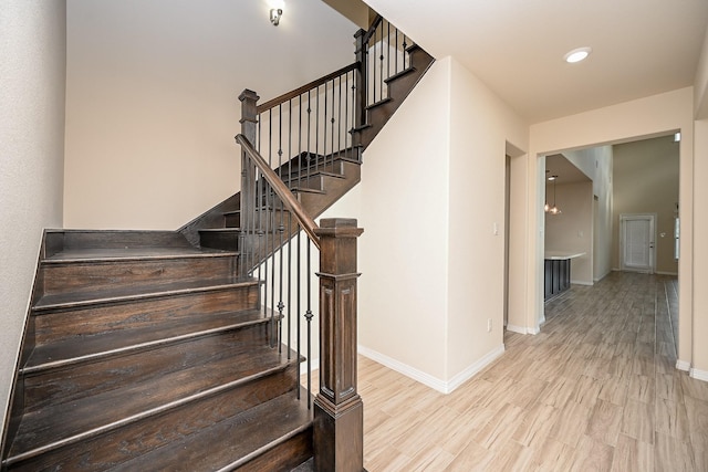 staircase featuring hardwood / wood-style flooring