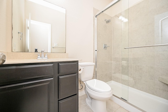 bathroom featuring tile patterned floors, vanity, toilet, and a shower with shower door