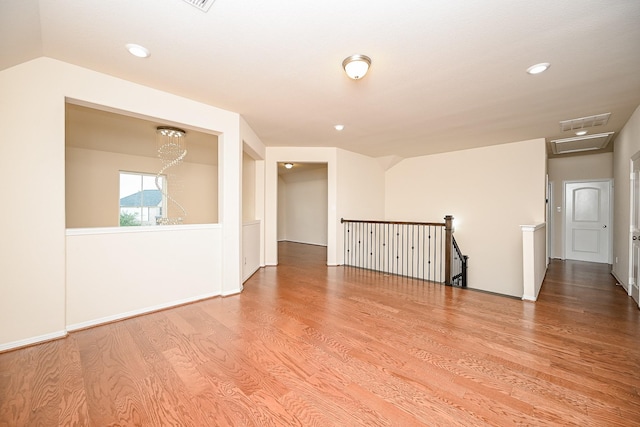 empty room featuring lofted ceiling and wood-type flooring