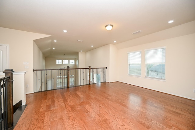 spare room with plenty of natural light and light hardwood / wood-style floors