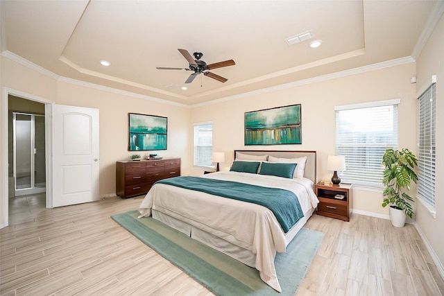 bedroom with a raised ceiling, ceiling fan, and light hardwood / wood-style flooring