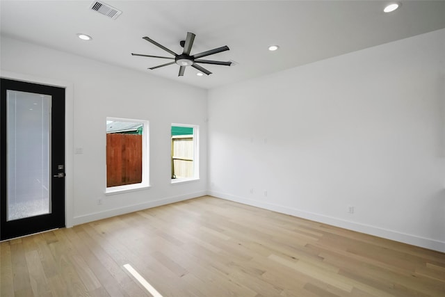 unfurnished room with ceiling fan and light wood-type flooring