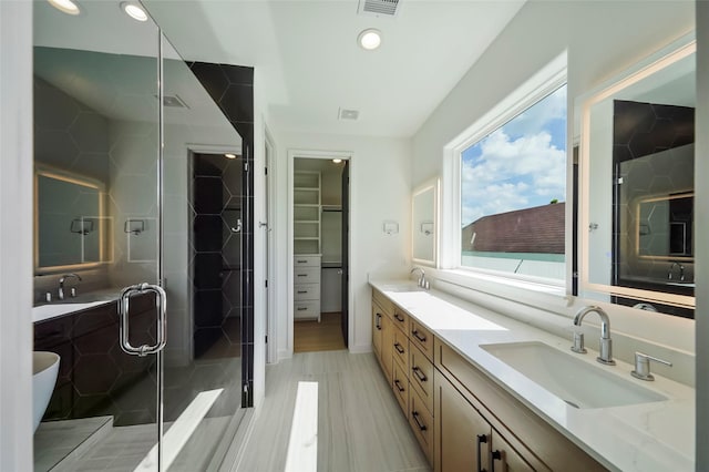 bathroom with vanity and a shower with shower door