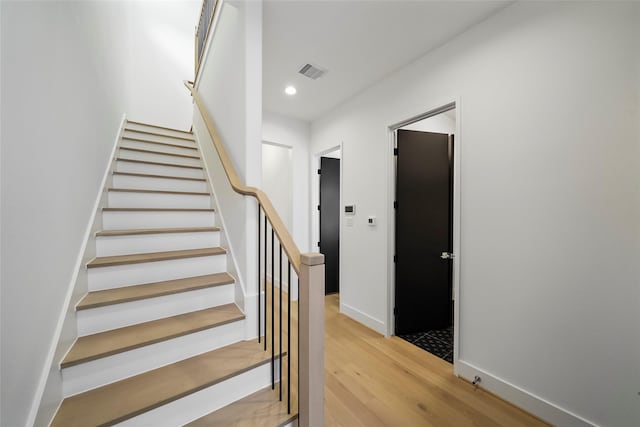 stairway featuring wood-type flooring