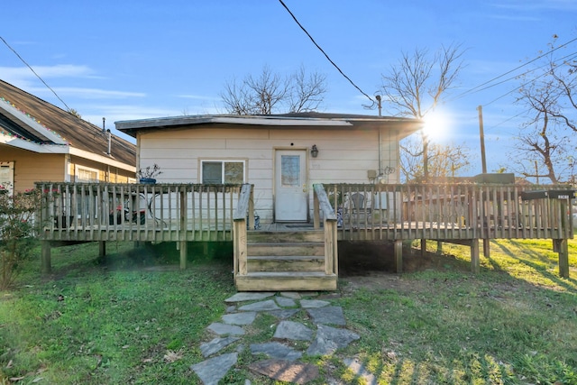 back of house with a yard and a deck