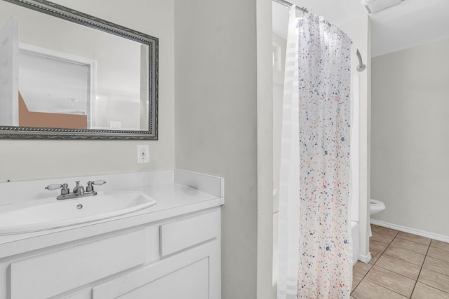 bathroom featuring tile patterned flooring, vanity, toilet, and a shower with shower curtain