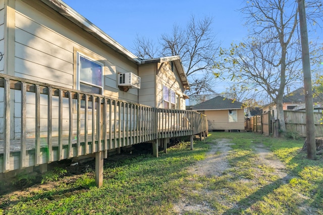 view of yard featuring a wall unit AC and a wooden deck