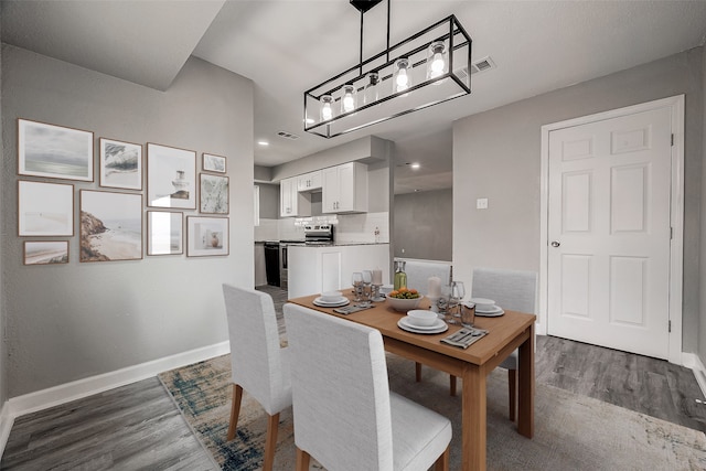 dining area with dark hardwood / wood-style flooring