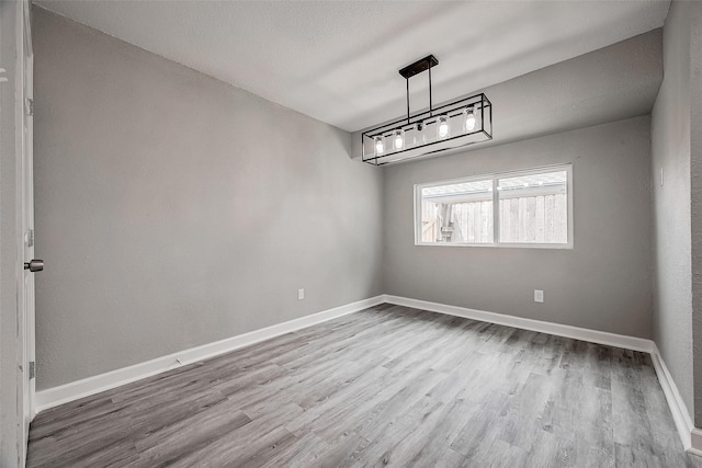 spare room with light hardwood / wood-style flooring