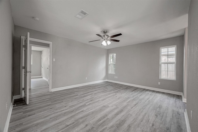 unfurnished room with ceiling fan and light wood-type flooring