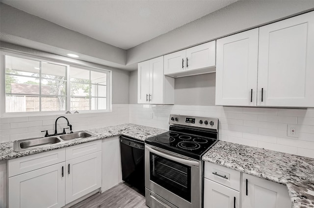 kitchen featuring white cabinets, sink, light hardwood / wood-style flooring, stainless steel electric range oven, and black dishwasher