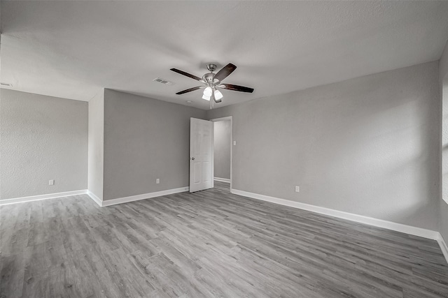 empty room featuring ceiling fan and light hardwood / wood-style flooring