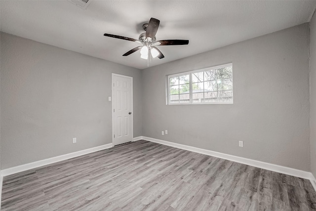 empty room featuring ceiling fan and light wood-type flooring