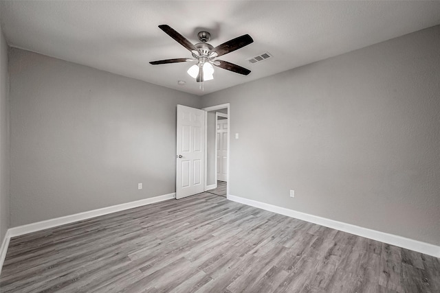 spare room featuring ceiling fan and light hardwood / wood-style floors