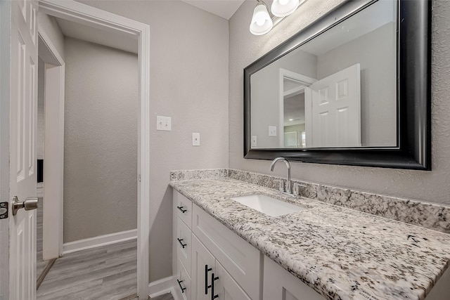 bathroom featuring hardwood / wood-style floors and vanity