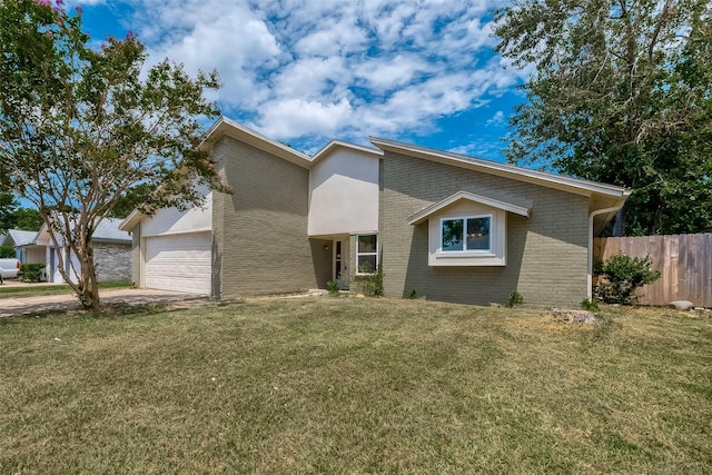 view of front of property featuring a garage and a front lawn