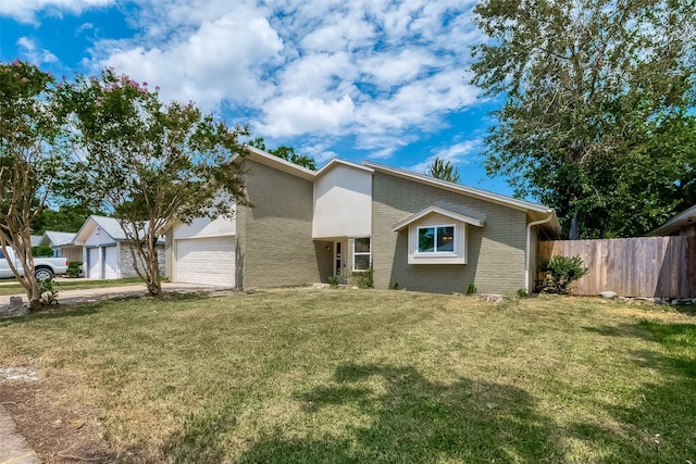 view of front of home with a garage and a front lawn