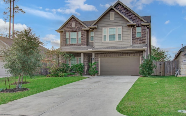 craftsman house featuring a garage and a front lawn