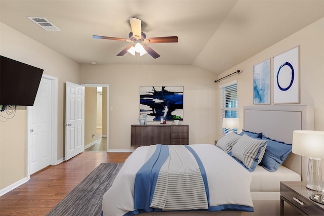 bedroom with ceiling fan, lofted ceiling, and hardwood / wood-style flooring