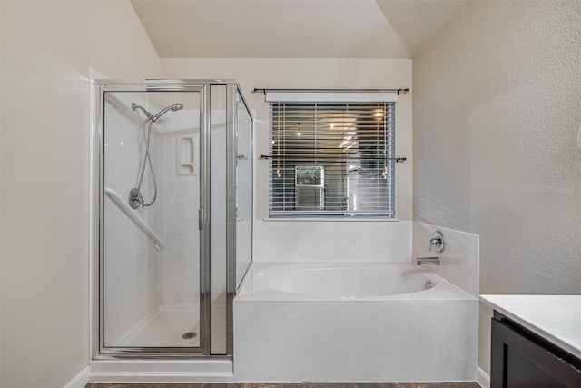 bathroom featuring vanity, lofted ceiling, and plus walk in shower