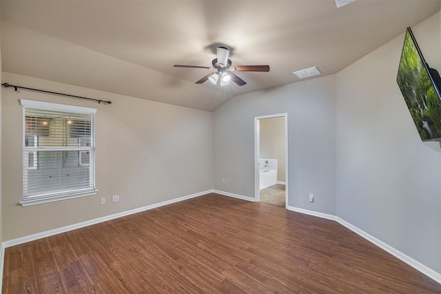 unfurnished room featuring dark hardwood / wood-style floors, ceiling fan, and vaulted ceiling