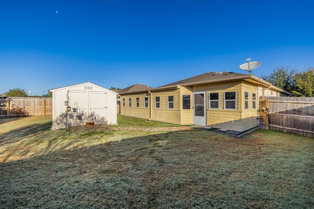 back of property with a storage shed and a lawn