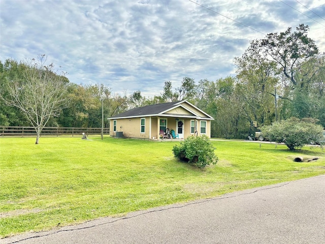 single story home featuring a front yard, a porch, and central AC