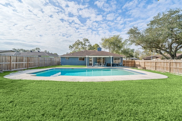 view of swimming pool featuring a yard and a patio