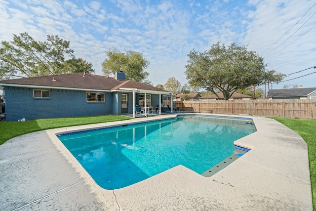 view of pool featuring a yard and a patio