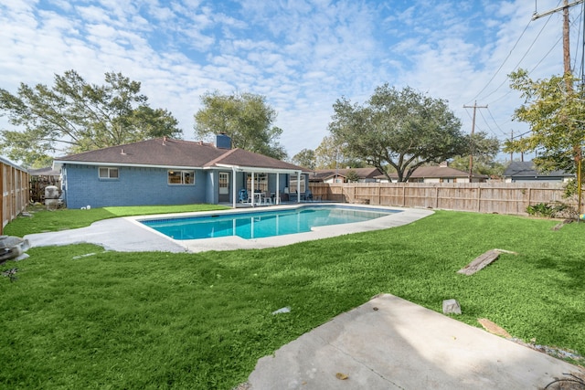 view of swimming pool with a yard and a patio