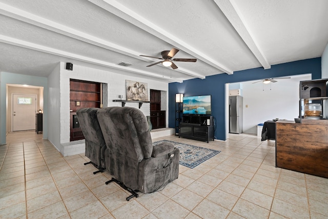 living room with beam ceiling, a textured ceiling, light tile patterned floors, and ceiling fan