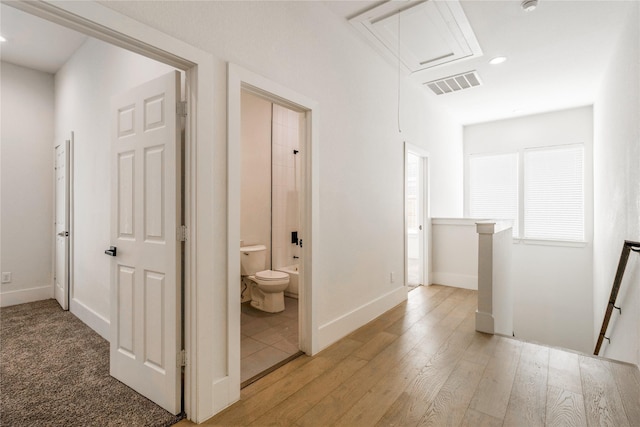 corridor with light hardwood / wood-style flooring